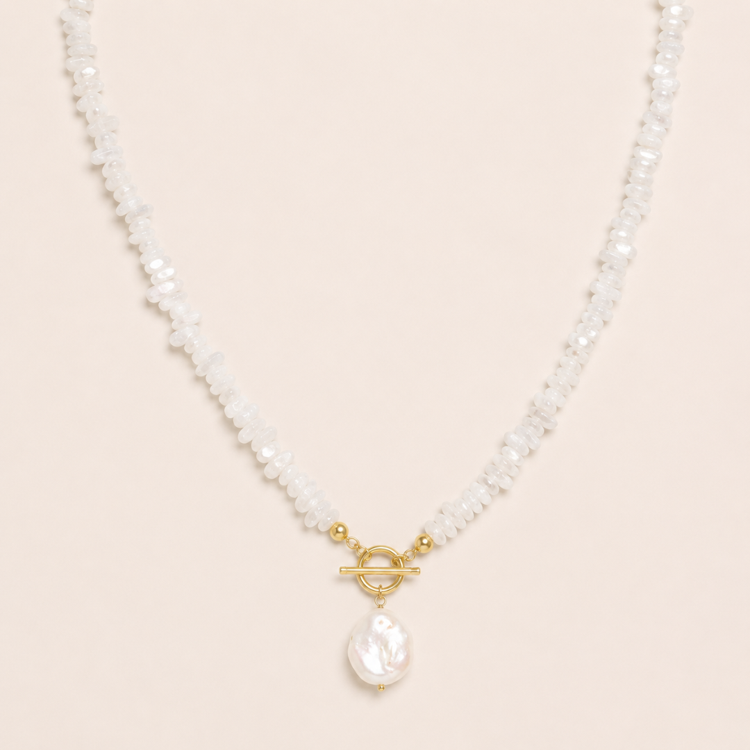 Pearl necklace with a gold clasp on a beige background