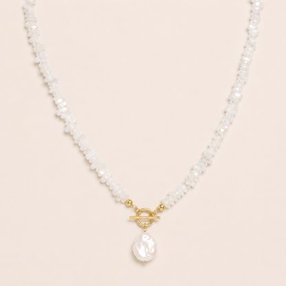 Pearl necklace with a gold clasp on a beige background