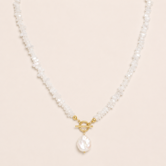 Pearl necklace with a gold clasp on a beige background