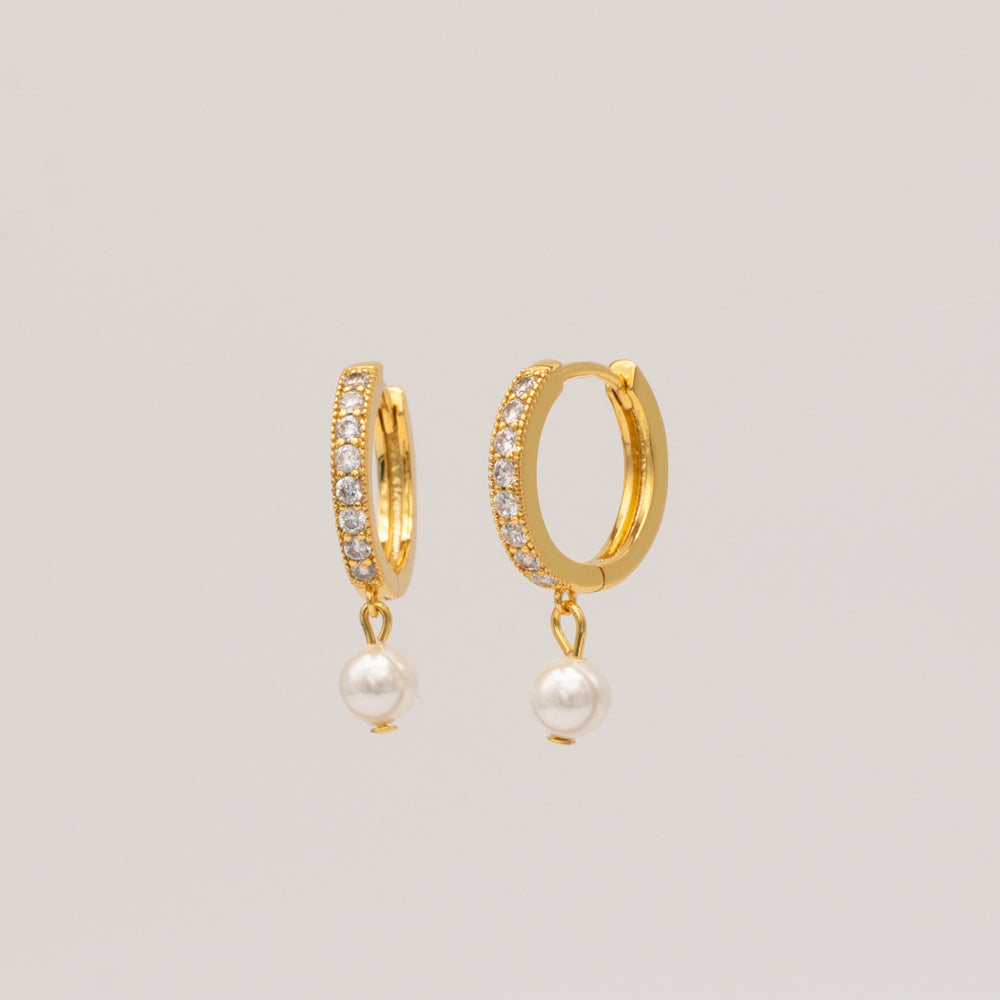 A pair of gold-plated hoop earrings with cubic zirconia stones and pearl accents.