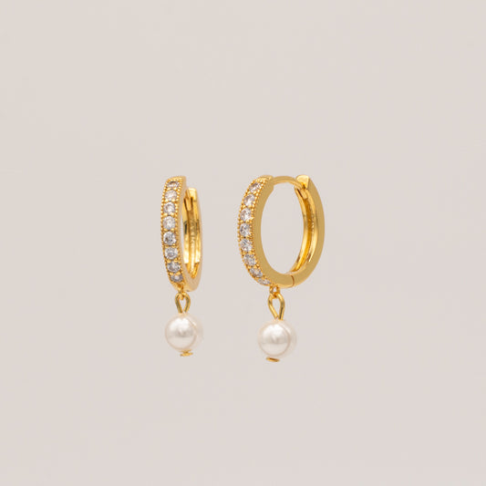 A pair of gold-plated hoop earrings with cubic zirconia stones and pearl accents.